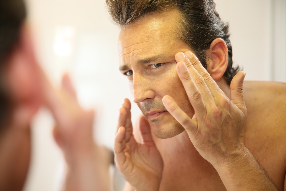Middle-aged,Man,In,Bathroom,Applying,Facial,Lotion Chemical Peels in Sugar Land, TX